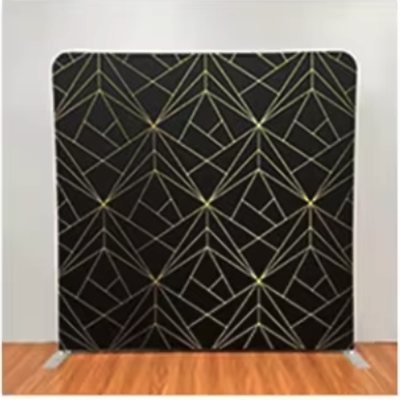 Black photo booth backdrop with a gold geometric line pattern