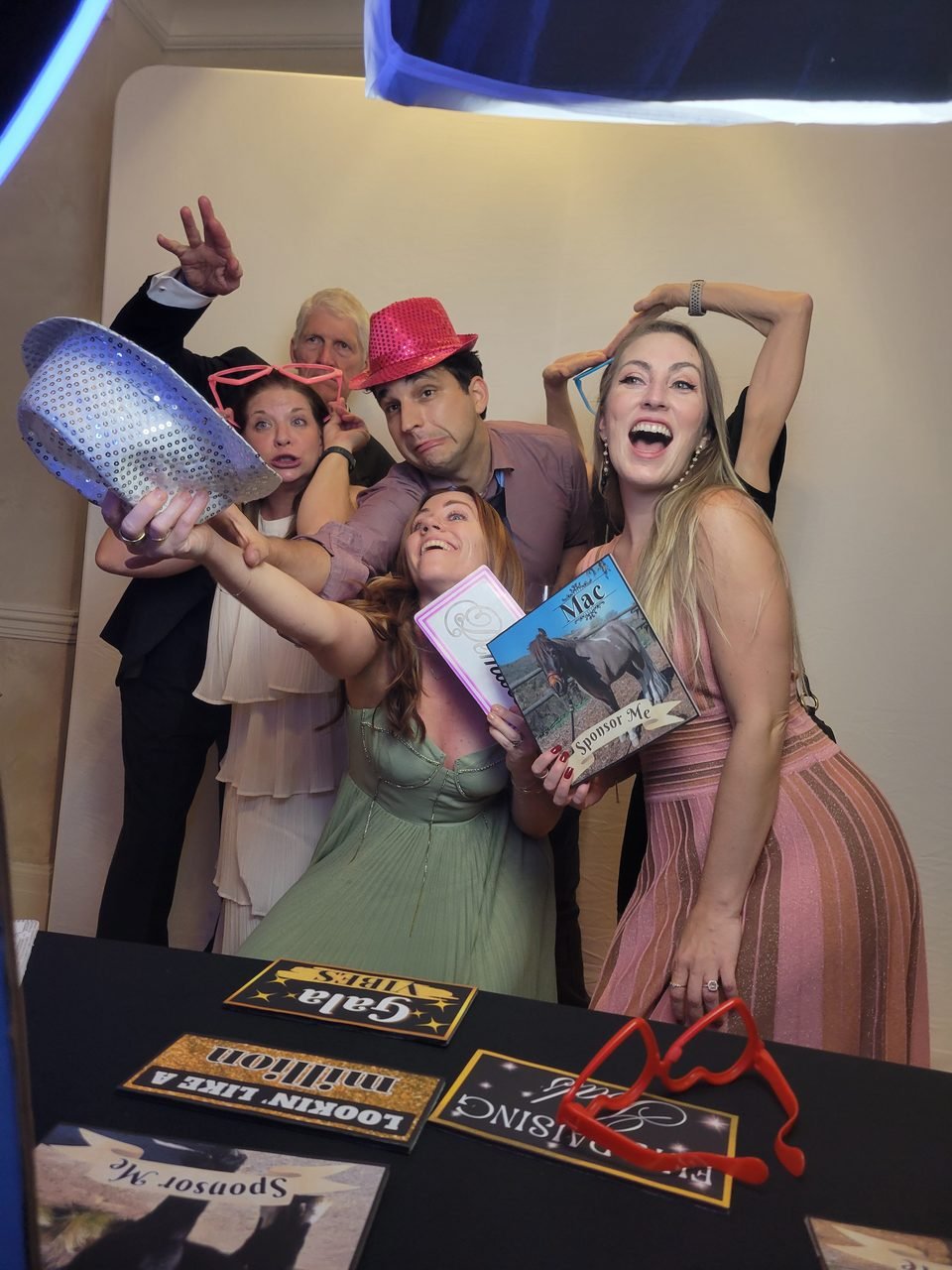 Gala guests laughing with SoCalFun365 photo booth props