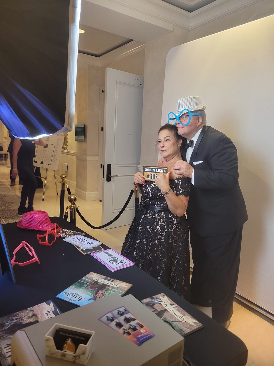 Guests posing at a SoCalFun365 classic photo booth at an Orange County gala